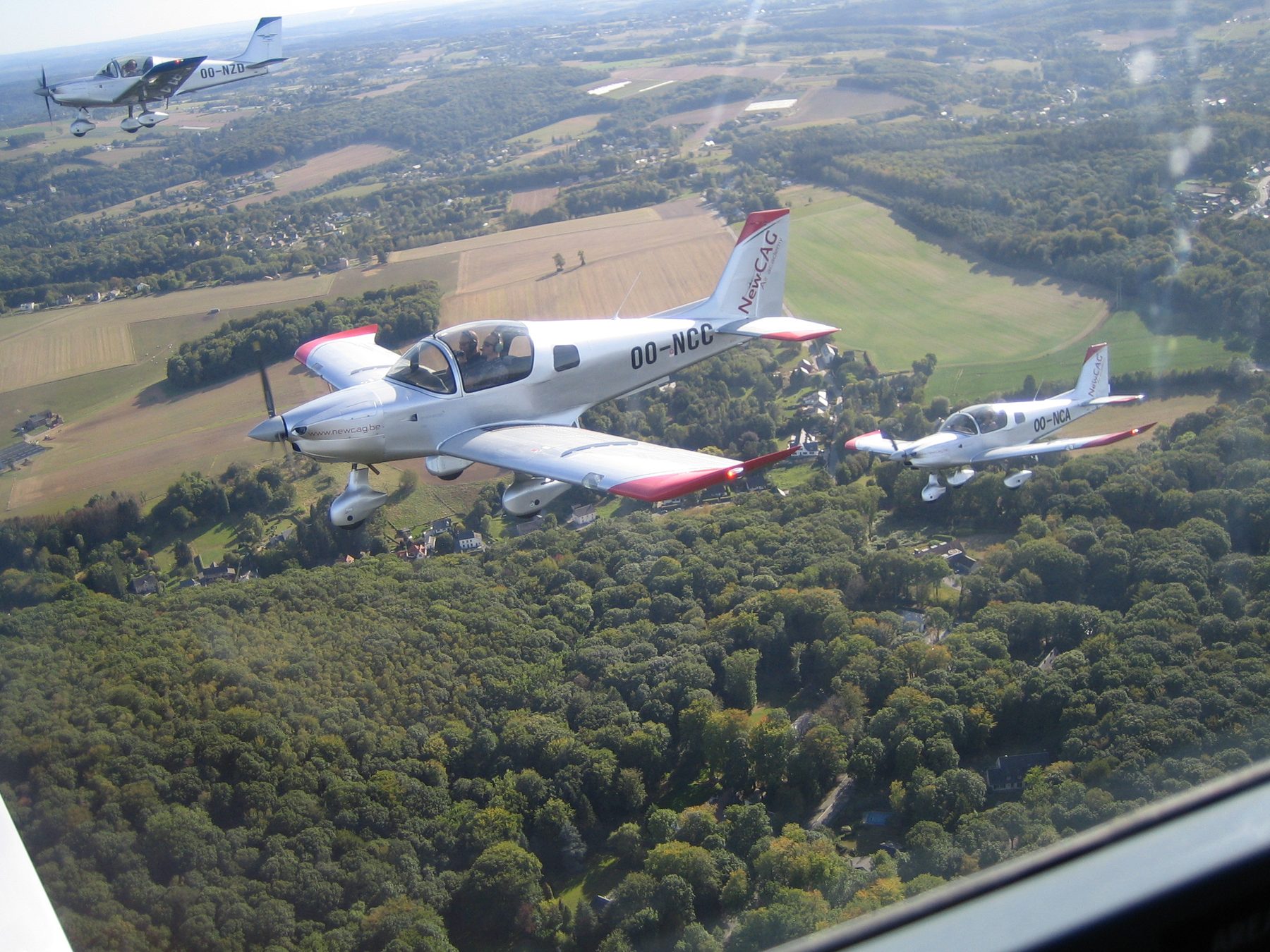 Two of the school’s Sonaca 200s in formation over the countryside