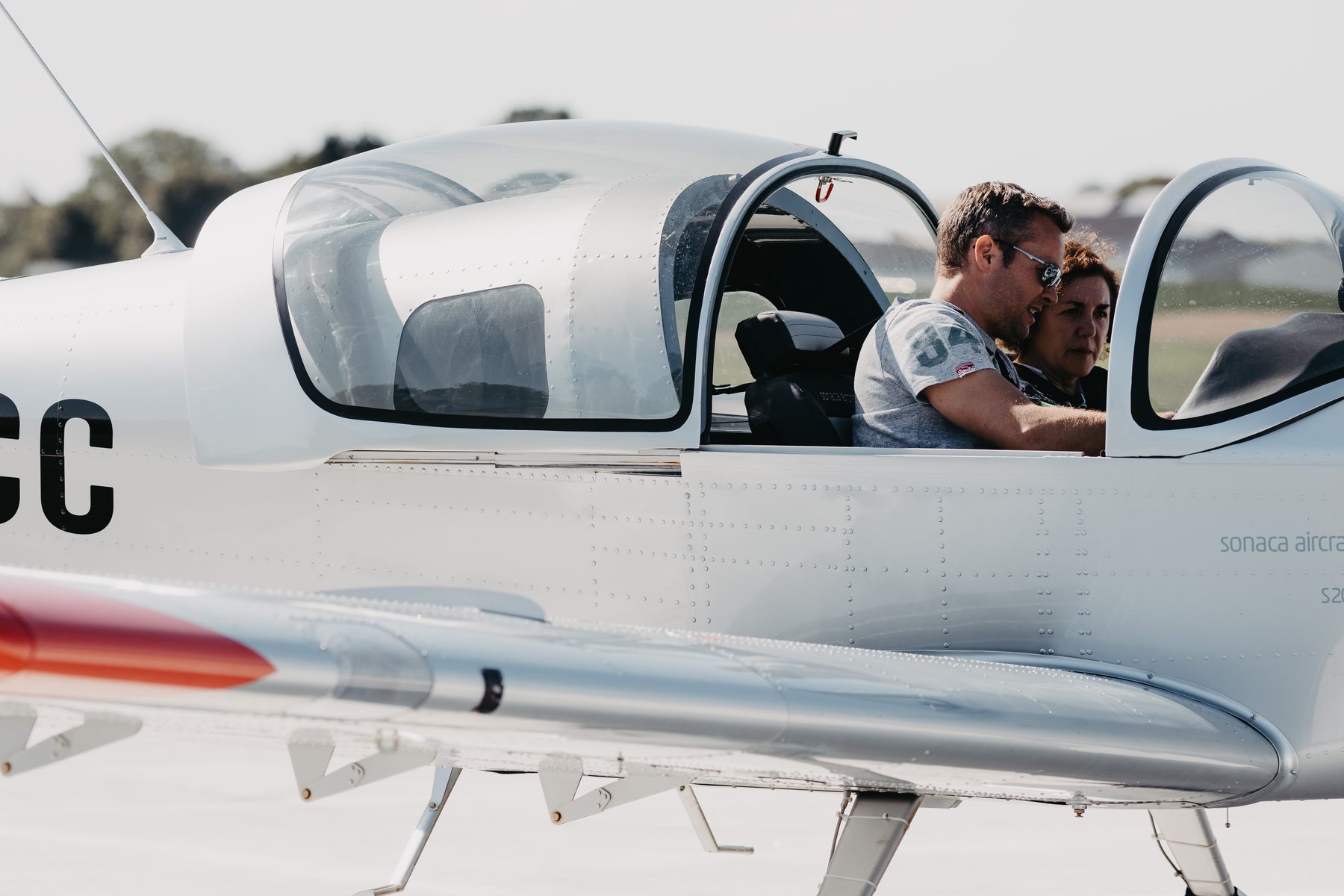 Des visiteurs découvrent le cockpit du Sonaca 200